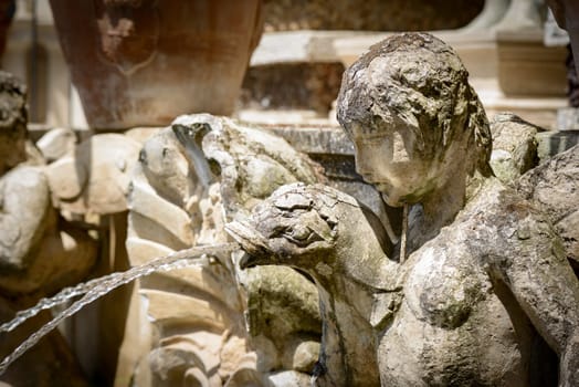 Particular of a fountain, angel statue, in Tivoli, Italy