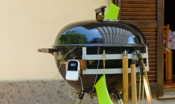 A closed barbecue during pulled pork cooking day, with tools