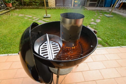 preparing briquette and barbecue for grilling meat