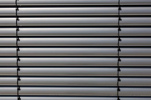 Silver-coloured blinds in detail