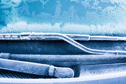 Iceflowers, frozen.The ice-cold frost forms ice crystals in beautiful unique patterns on the window, Hood and wiper on the Car
