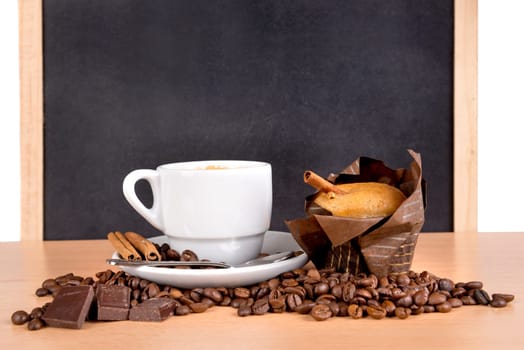 coffee cup with coffee beans, chocolate and muffin