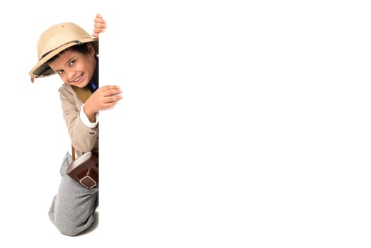 Young boy with Safari clothes behind a white board isolated in white