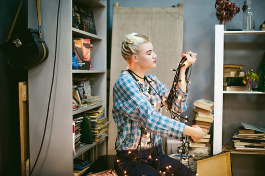 Portrait of a young woman with lights. beautiful girl with white hair dyed, holding christmas lights