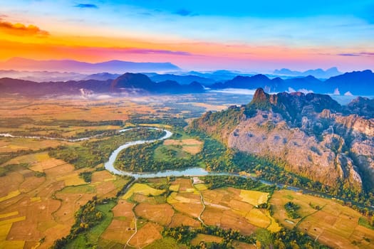 Aerial view of the fields, river and mountain. Beautiful landscape. Vang Vieng. Laos.