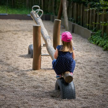 lonely little girl alone on a playground