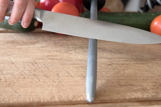 Knife on honing steel at 20 degree angle .
