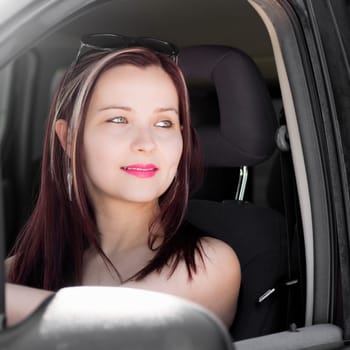 Female driver, pretty cute woman is in the car. Transportation.