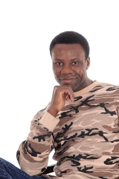 A happy and handsome African American man sitting with his hand.on his chin in a sweeter, isolated for white background.