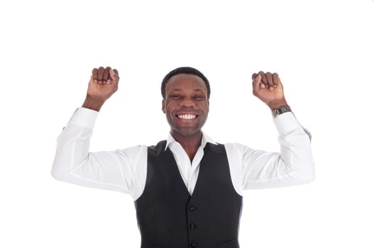 A young happy African American man in a white shirt and vest with.his arms raised for victory, isolated for white background.