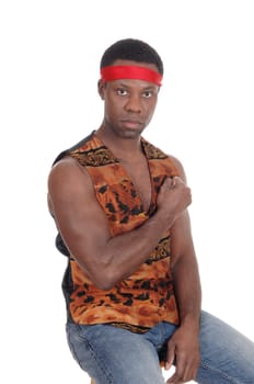 A handsome African American man sitting in a vest making a fist and .looking angry, isolated for white background.