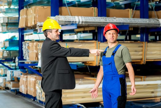 in the factory- boss and worker in conversation