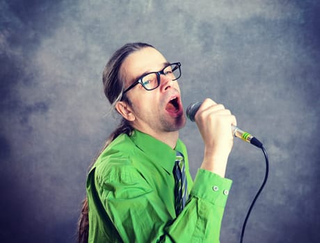young crooner in green shirt and necktie