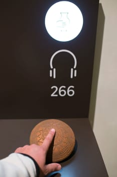 Madrid, Spain - November 11, 2017: Tactile display. Blind visitor touching a neolithic pottery replica at National Archeological Museum of Madrid