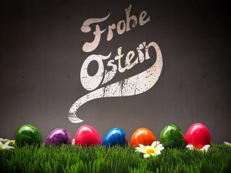 Colorful Easter eggs in a row on grass
