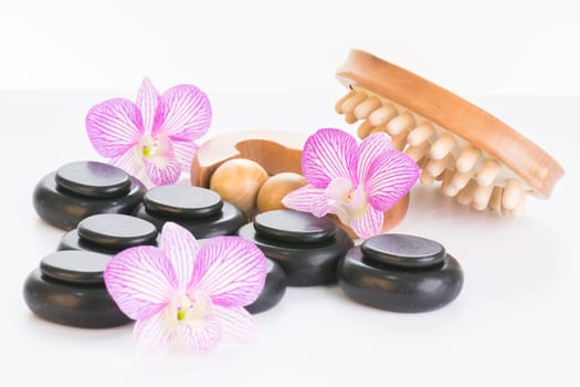Spa therapy with hot stones, massage roller and cellulite massager