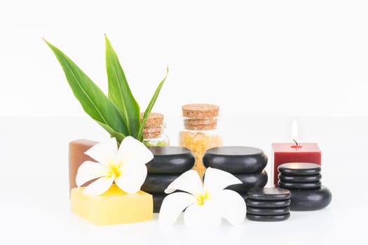 Spa with hot stones, soaps, bath salt and candle close up