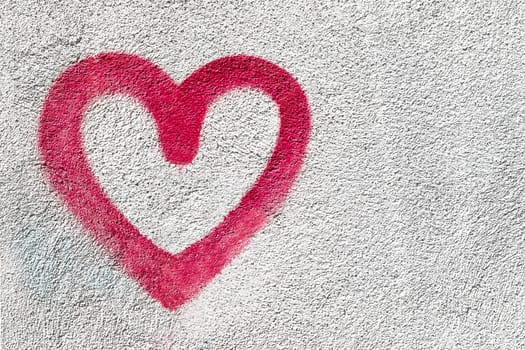 Red heart symbol. Grungy wall background. Fall in love and Valentine's day concept.