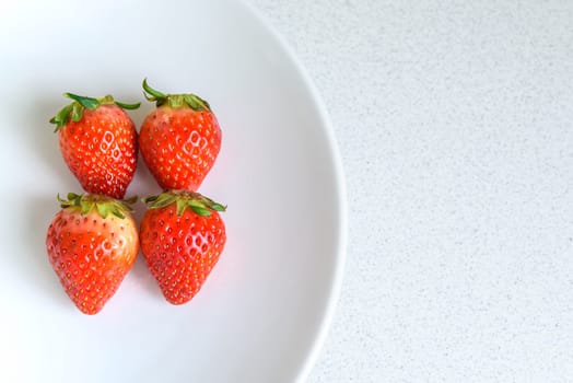 Strawberry on the plate with copy space, selective focus