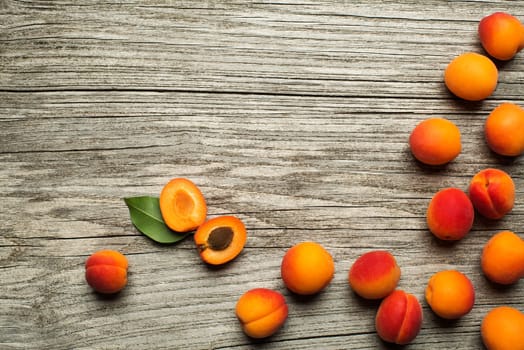 Delicious ripe apricots fruit on wooden background close up