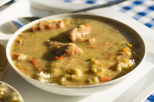 Savory sauce from vegetable with meat and rice is in white plate.