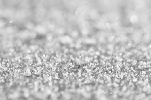 Macro photo of snow and ice crystals as winter texture background.