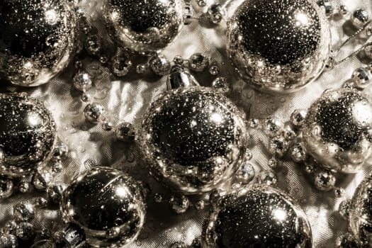 Silver spheres and pearls texture as Christmas decoration.