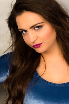 Pretty young woman is looking at the camera and posing.