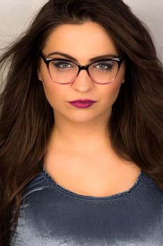 Beauty portrait of attractive woman with makeup and glasses.
