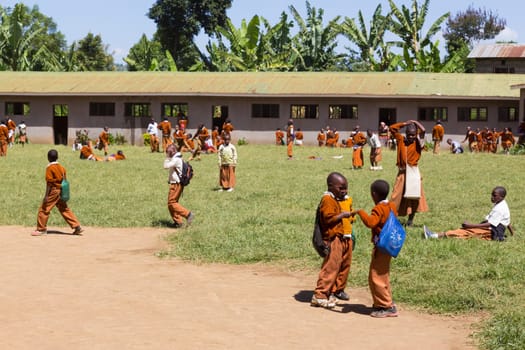 Arusha, Tanzania- Jan 26, 2015: Children in uniforms playing in the cortyard of primary school on January the 26th, rural area near Arusha, Tanzania, Africa.