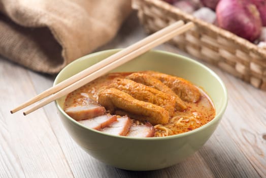 Hot and spicy Malaysian curry noodle on table.