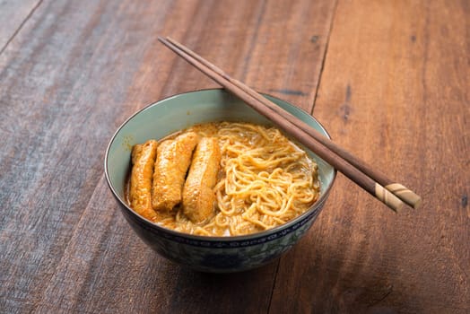 Hot and spicy Malaysian Curry Noodle or laksa mee, serve with chopsticks. Malaysia cuisine.