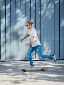 Man,27 years old,rides on longboard,urban environment