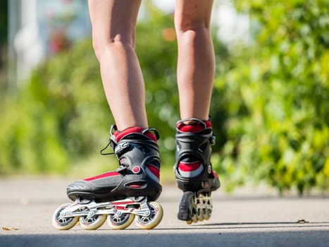 Woman,22 years old,inline skating,detail shot skates and legs,residential area