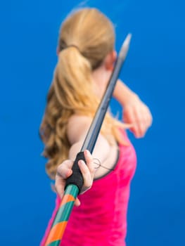 young woman throwing javelin in athletics