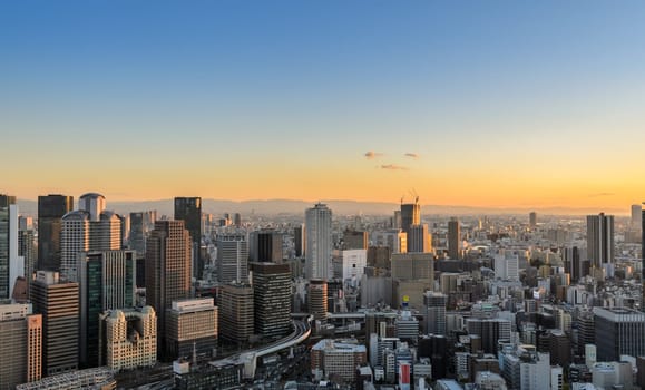 OSAKA, JAPAN - NOVEMBER 25, 2016 : Osaka commercial and business cityscape at sunset from Umeda Sky Building in Osaka, Japan. Osaka is the second largest metropolitan area in Japan.