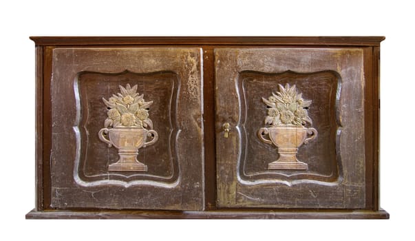 Very old wooden decorated commode on white background