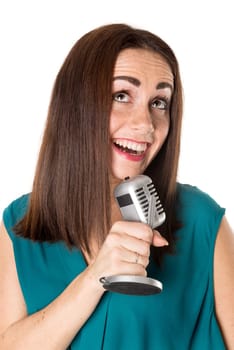 Casual young woman with a microphone isolated in a white background