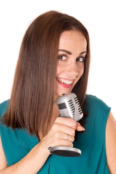 Casual young woman with a microphone isolated in a white background