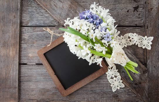 Small bouquet of fresh hyacinths on a rustic wooden background