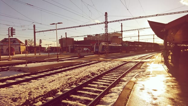 BRNO, CZECH REPUBLIC - 19TH JANUARY 2018 - People waiting for a trains at platform during rush hour at sunset in Brno Main Railway Station in Brno, Czech Republic.