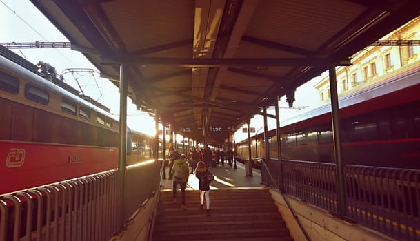 BRNO, CZECH REPUBLIC - 19TH JANUARY 2018 - People waiting for a trains at platform during rush hour at sunset in Brno Main Railway Station in Brno, Czech Republic.