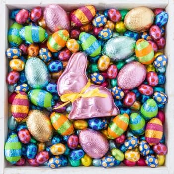 Lots of colorful Easter eggs and chocolate bunnies