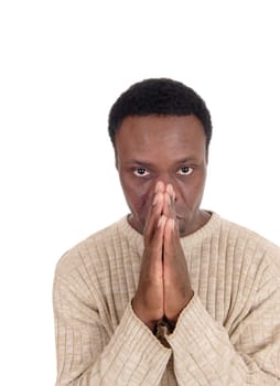 A young African American man in a portrait image with his hands.folded praying to God, isolated for white background.