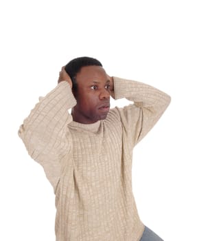 A young African American man looking horrified and scary with his.hands on his head and big eyes, isolated for white background.