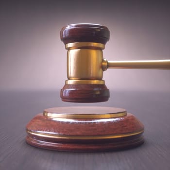 Gavel, judge hammer. Close up of wooden hammer with gold details. Concepts of law and auction.