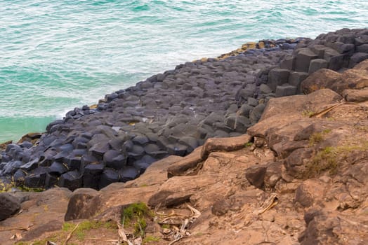 Crescent shaped hexagonal rock formations at Fingal Head, Australia