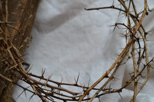 crown of thorns, a piece of cloth like a shroud and an old wooden beam