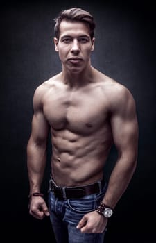 Handsome young strong man posing bare chest