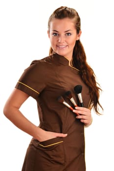 Professional beautician holding brushes